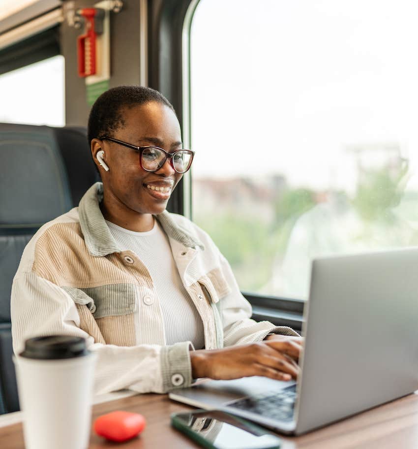 Self educated woman works on laptop while traveling is on the path to prosperity