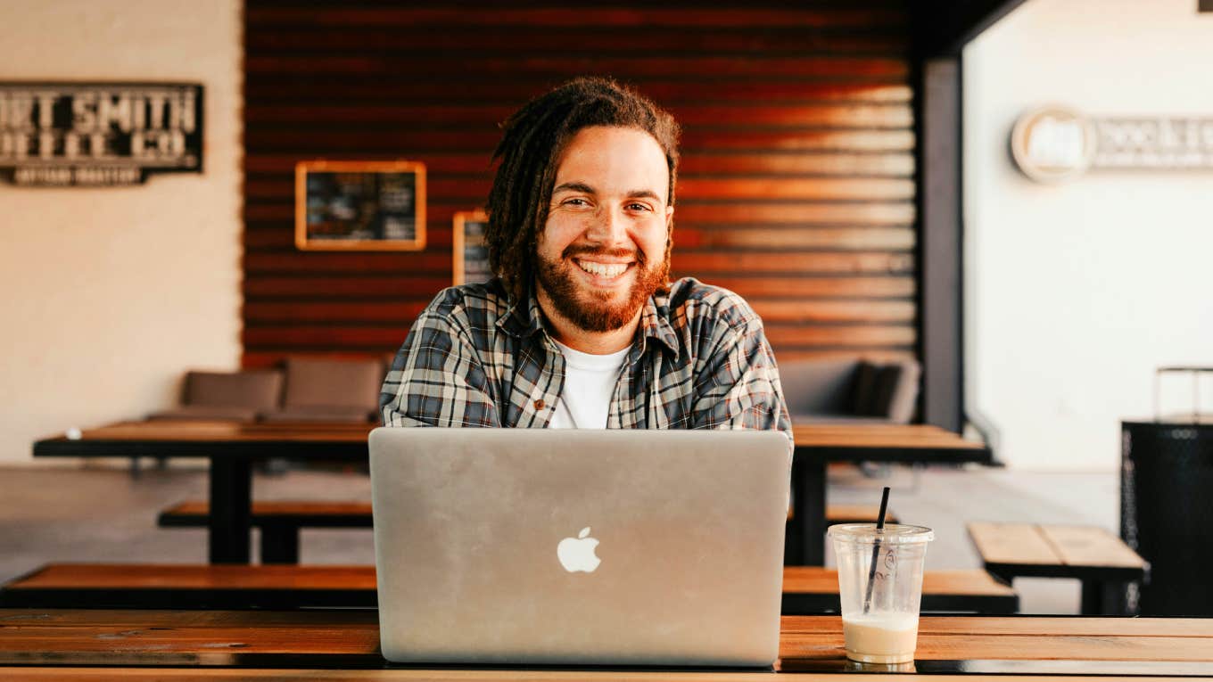 Young wealthy man sitting at his computer.