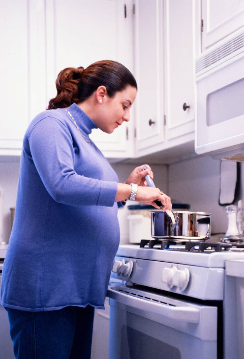 pregnant wife cooking dinner