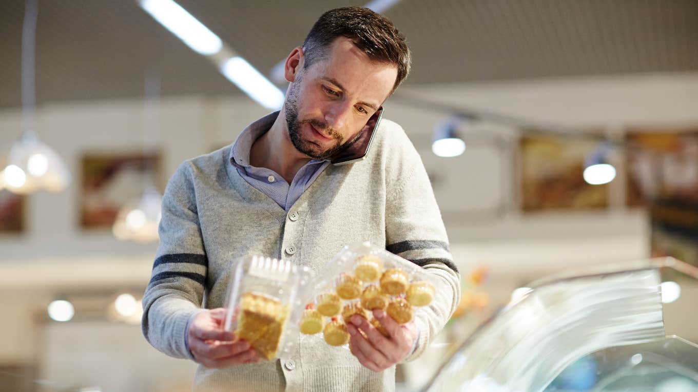 Confused husband in the grocery store calling his wife