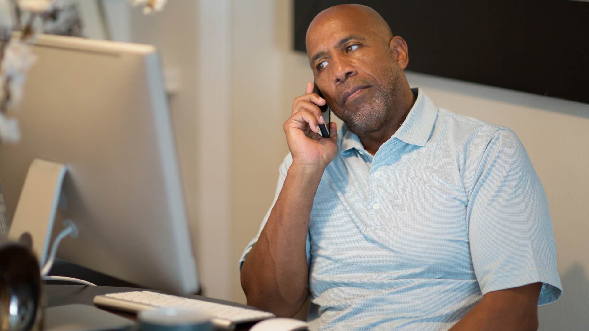 Boomer man looking annoyed talking on the phone