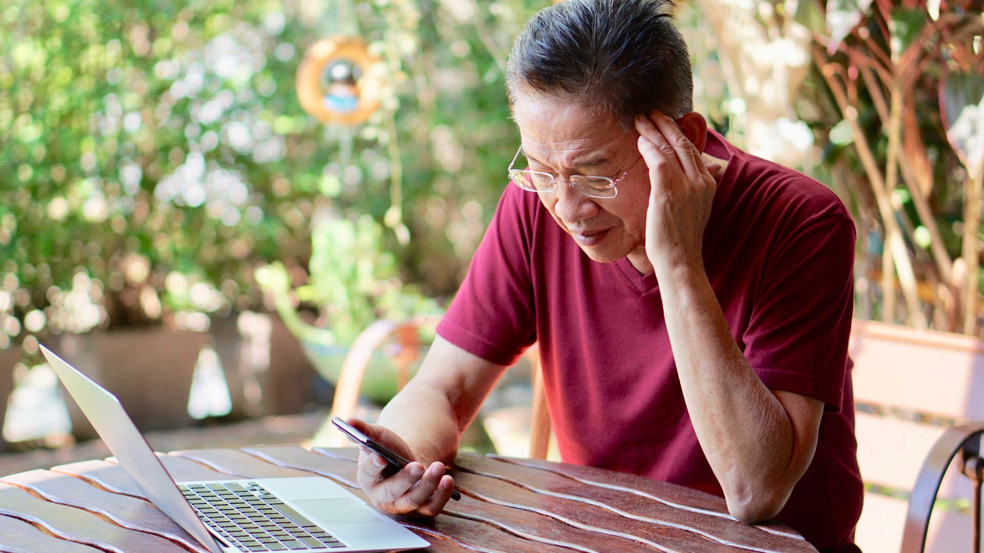 Boomer man looking sad swiping on his phone