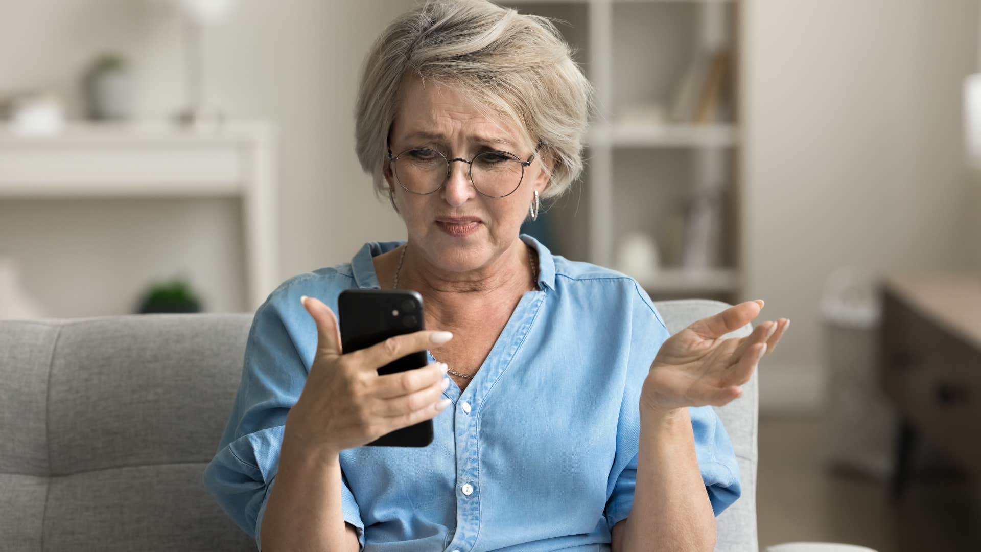 Boomer woman looking shocked staring at her phone