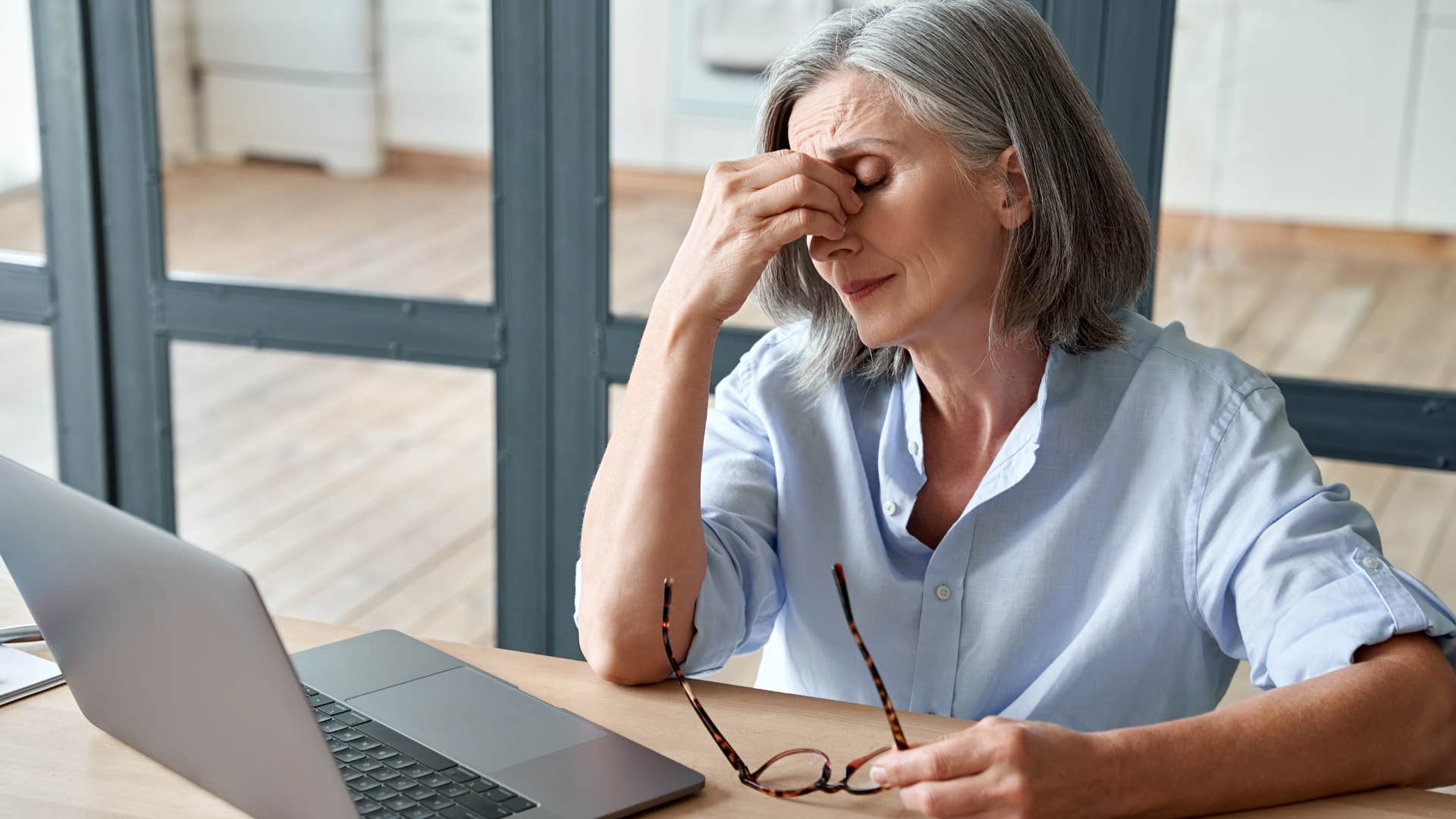 Boomer woman looking annoyed staring at her laptop