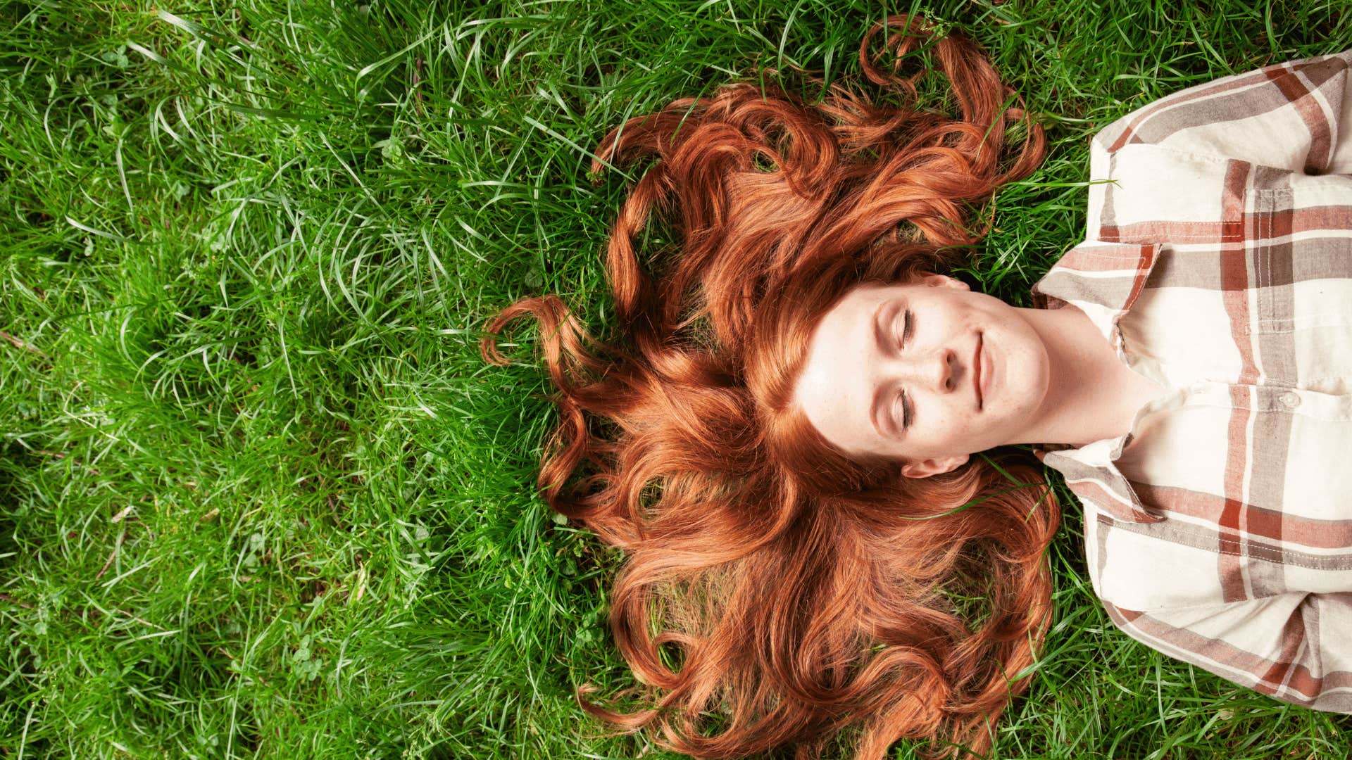 woman laying in the grass