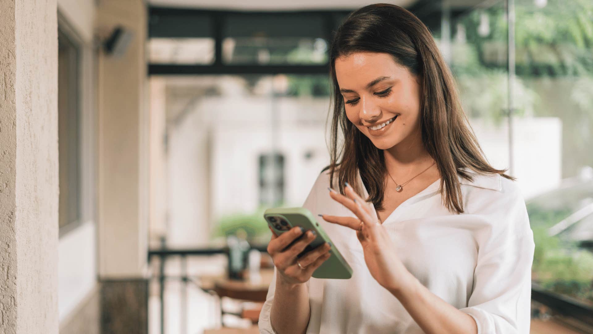 woman smiling while on the phone