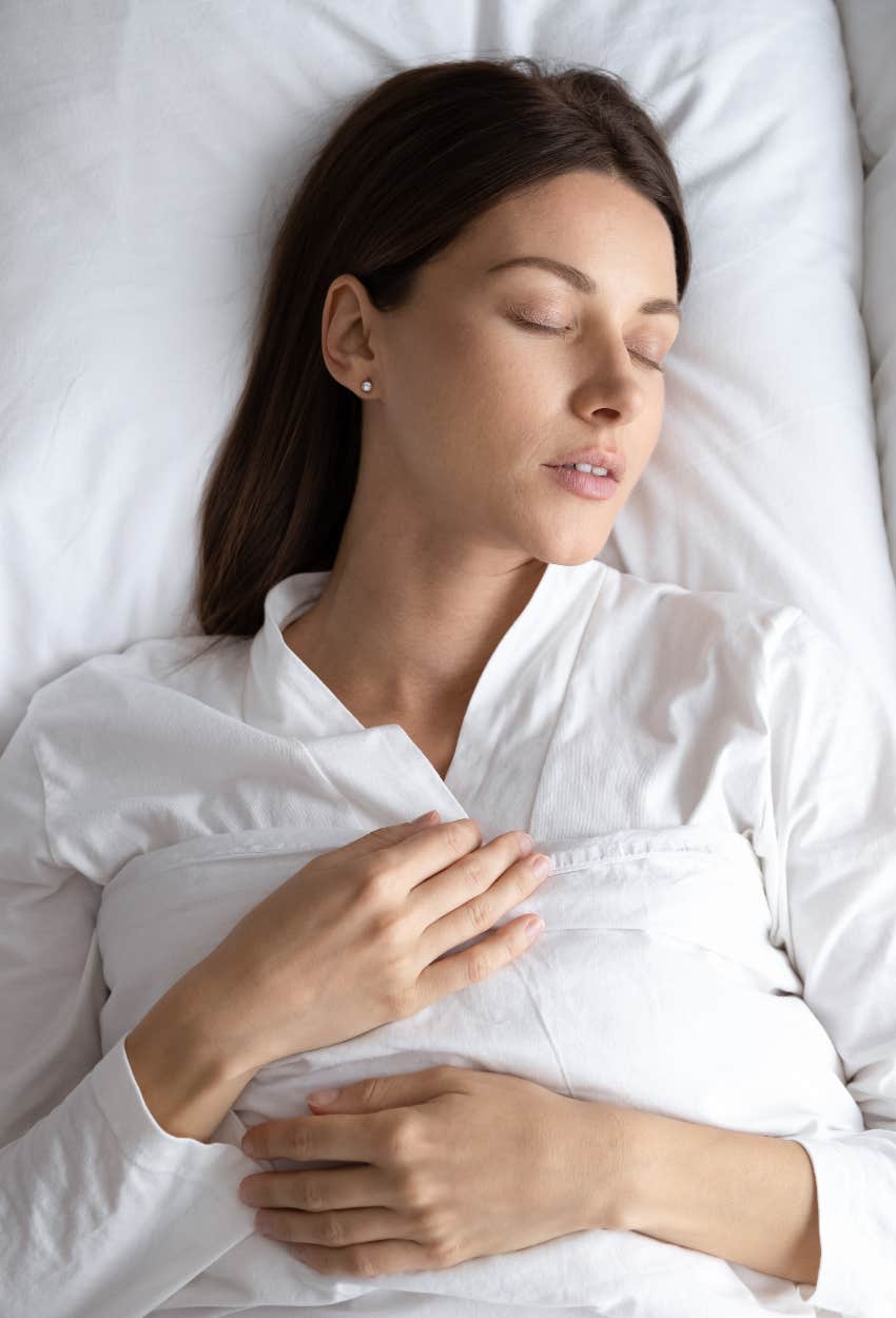 Woman doing a body scan in bed