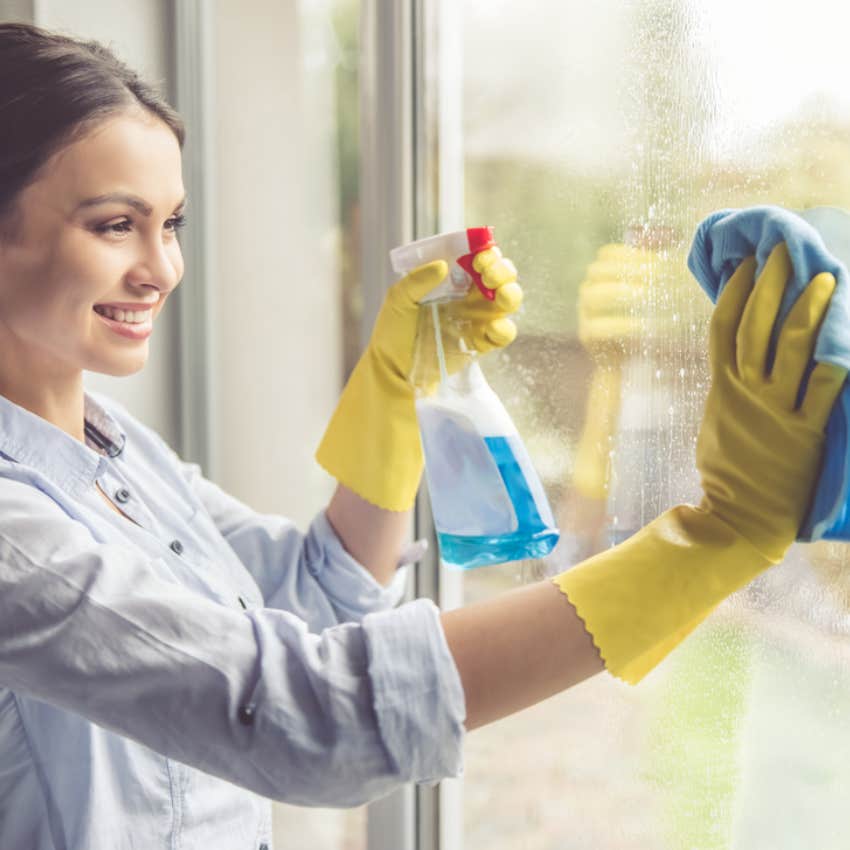 woman cleaning glass door 