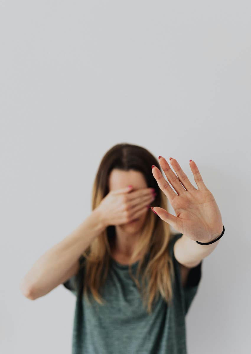 woman covering her face with her hand