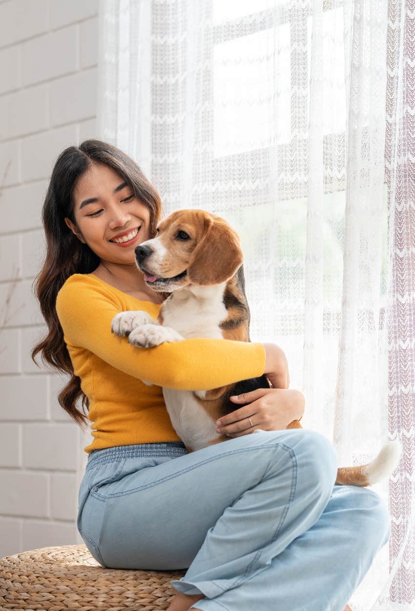 Dog owner hugging her dog