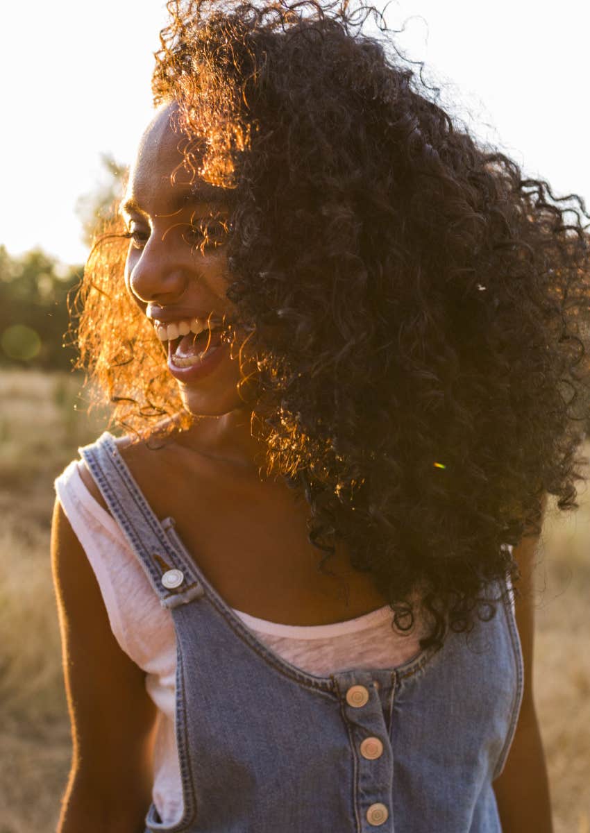 Woman laughing wearing natural hair