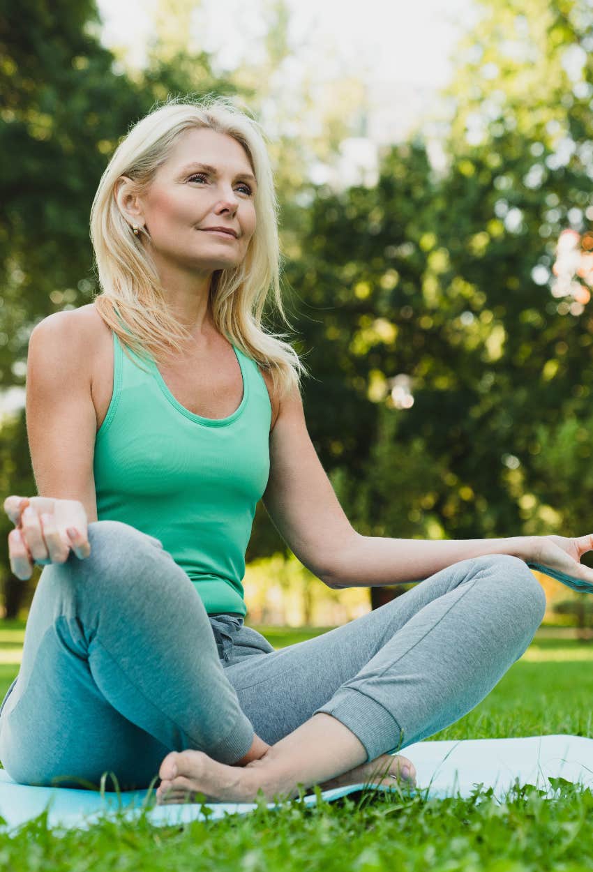 Happy worker meditating outside