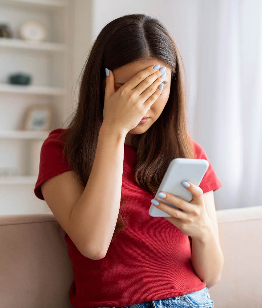 Woman reading on offensive message on a dating app