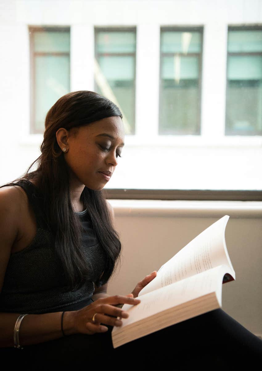 woman sitting down reading