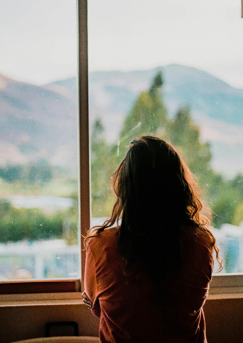 lonely woman staring out window