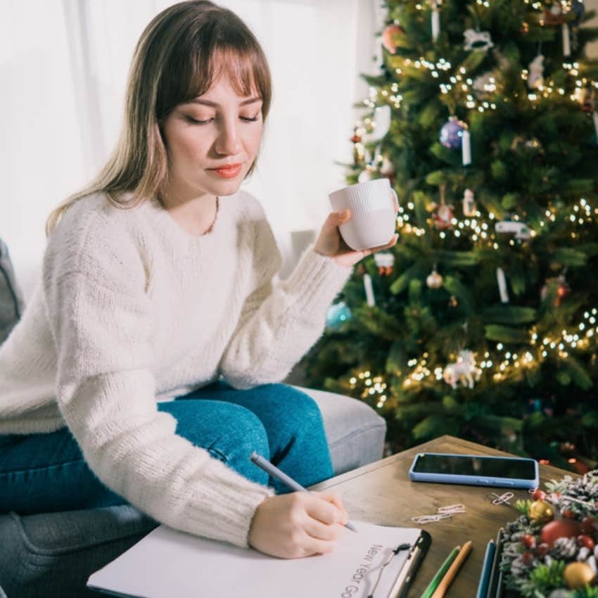 woman writing down new years resolutions 