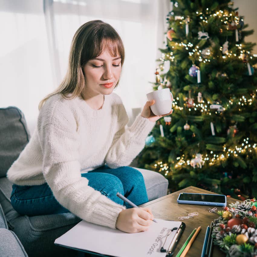 Woman writing New Year's Resolutions