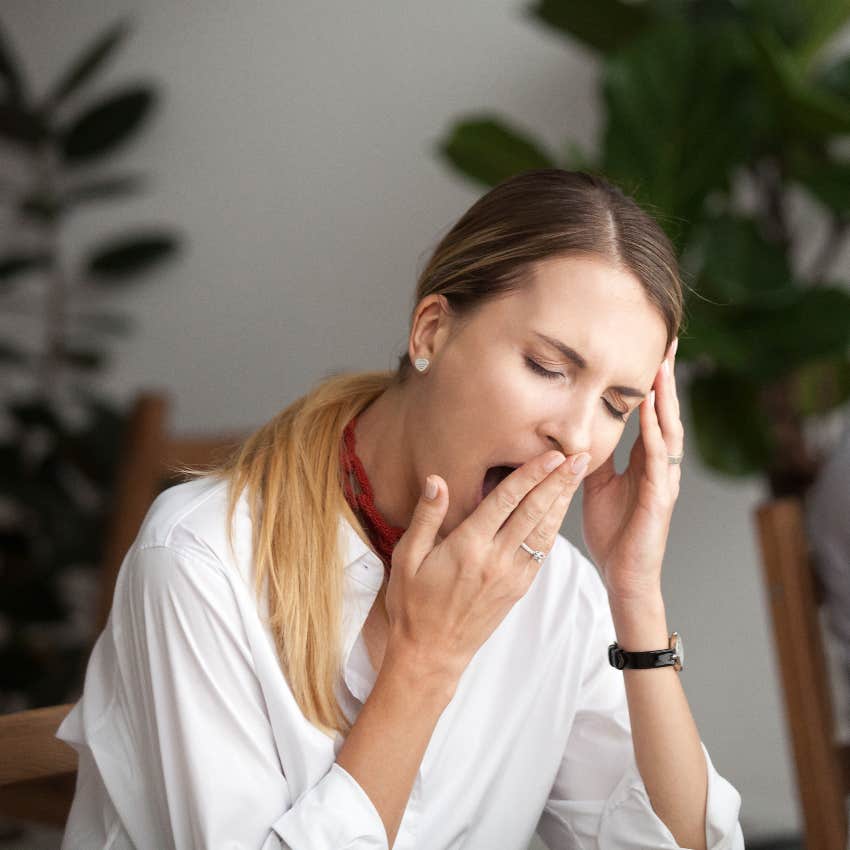 Woman yawning because of stagnant emotions