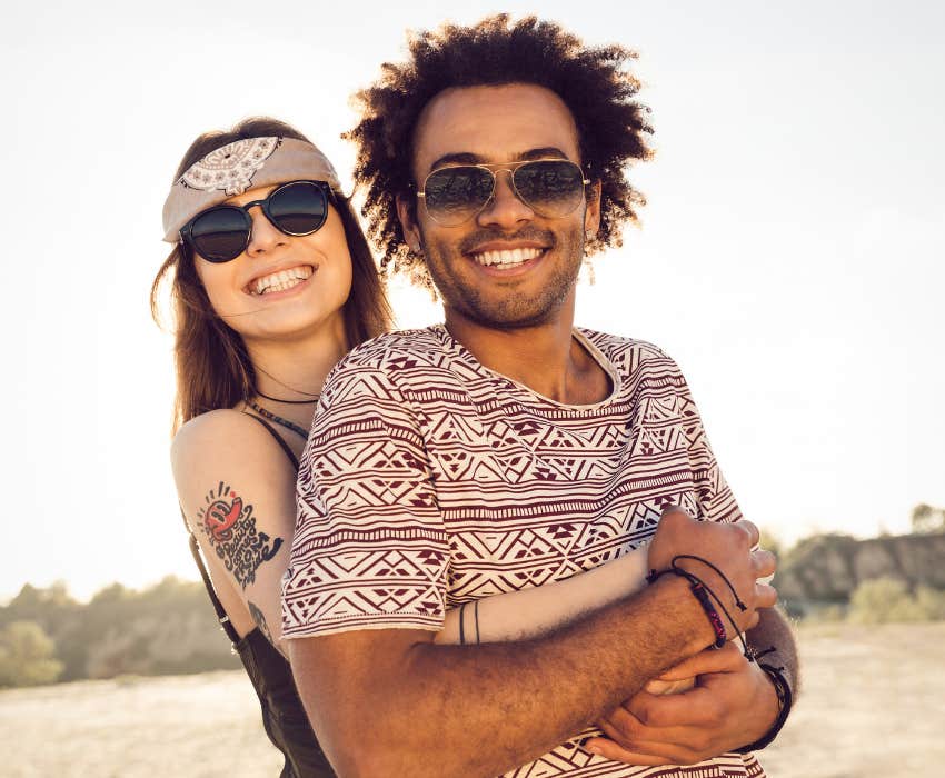 Happy smiling young couple embracing on the beach