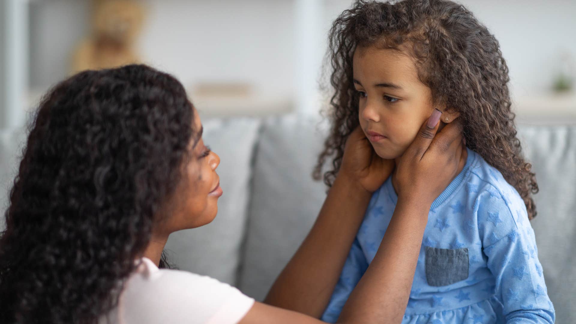 Woman comforting her upset daughter.