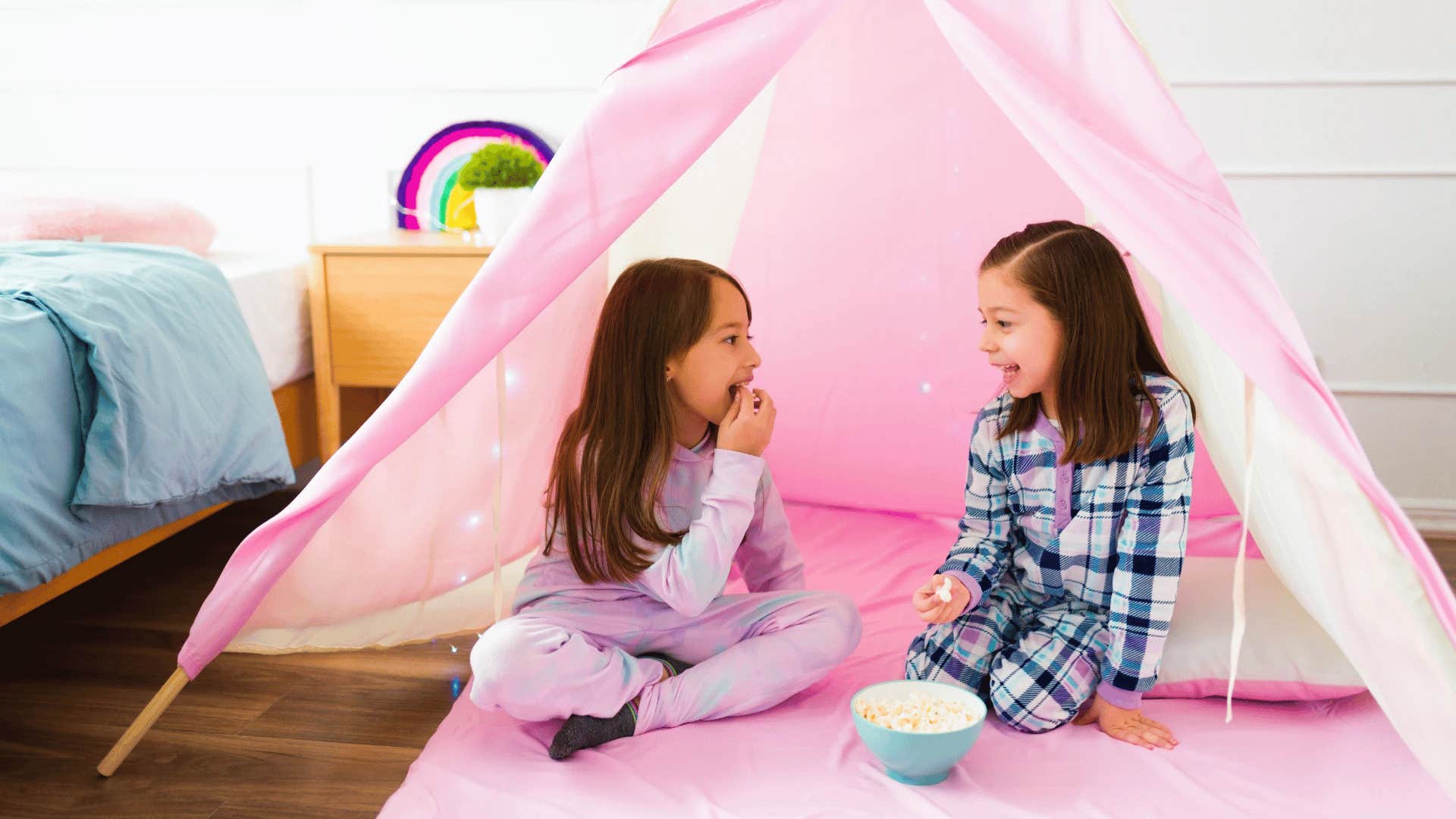 girls having a sleepover in a tent