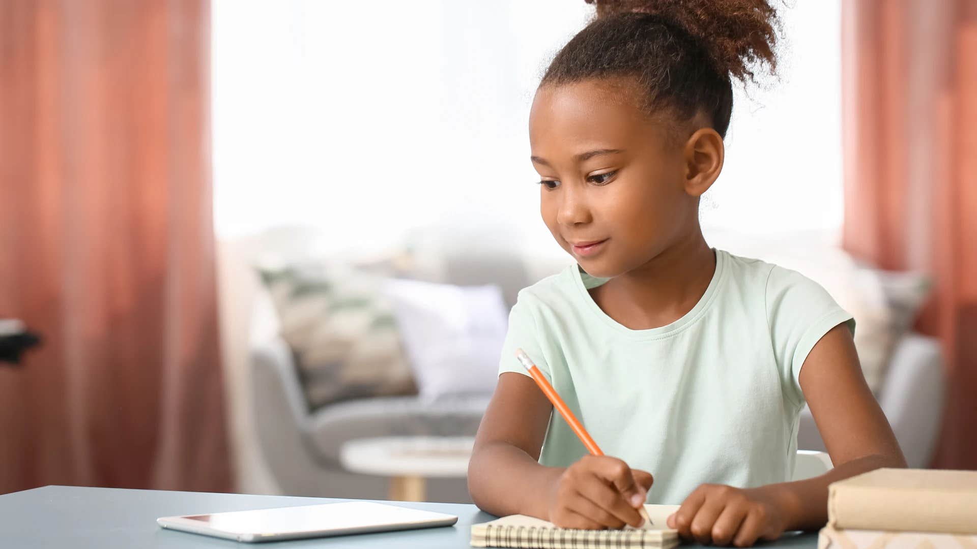 little girl writing thank you cards