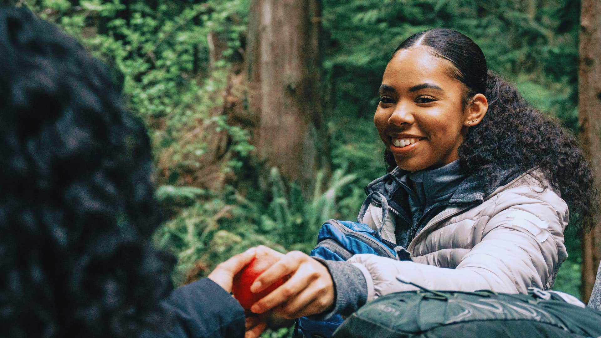 woman sharing an apple with a friend