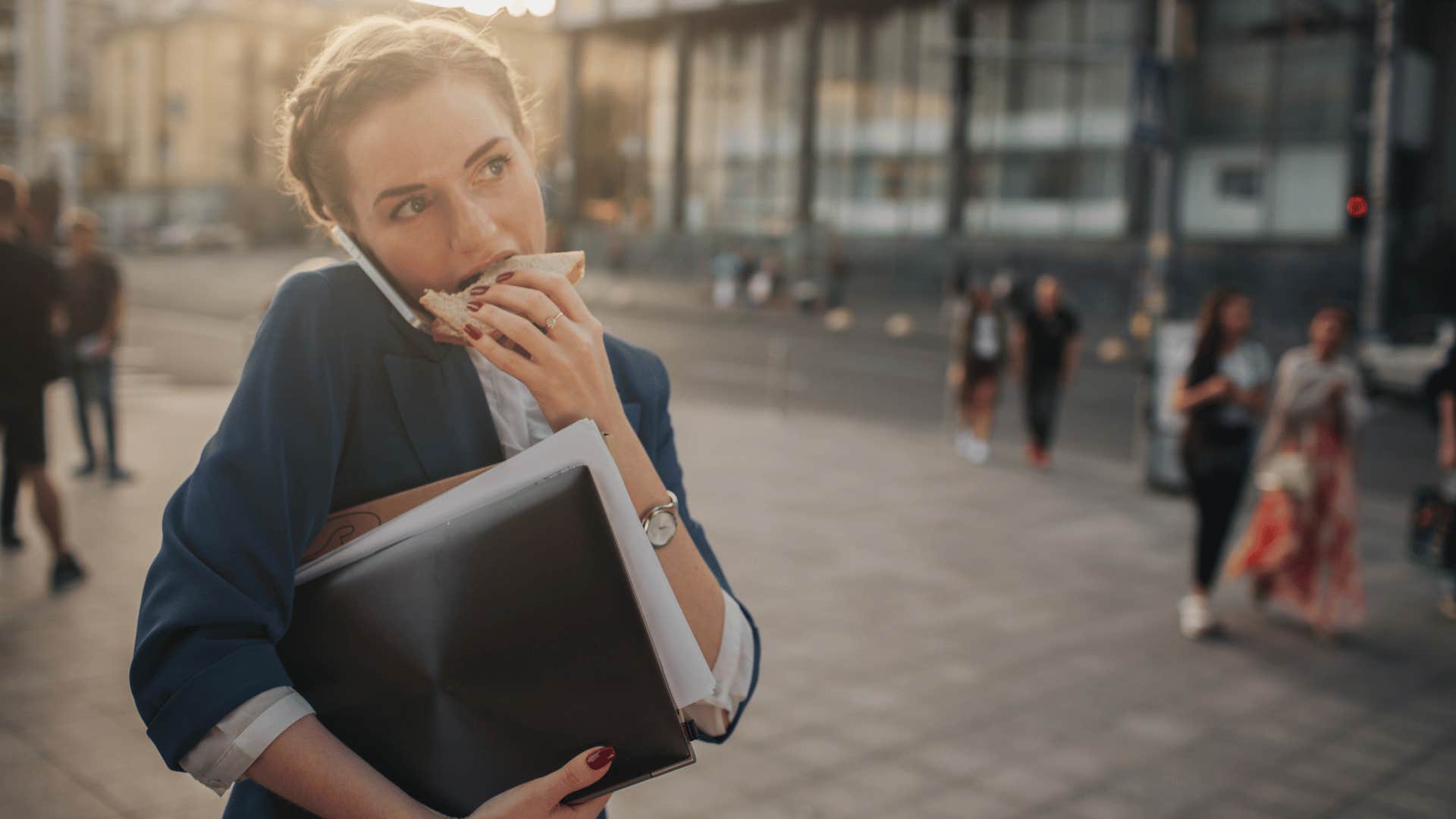 woman eating while walking to work in a rush