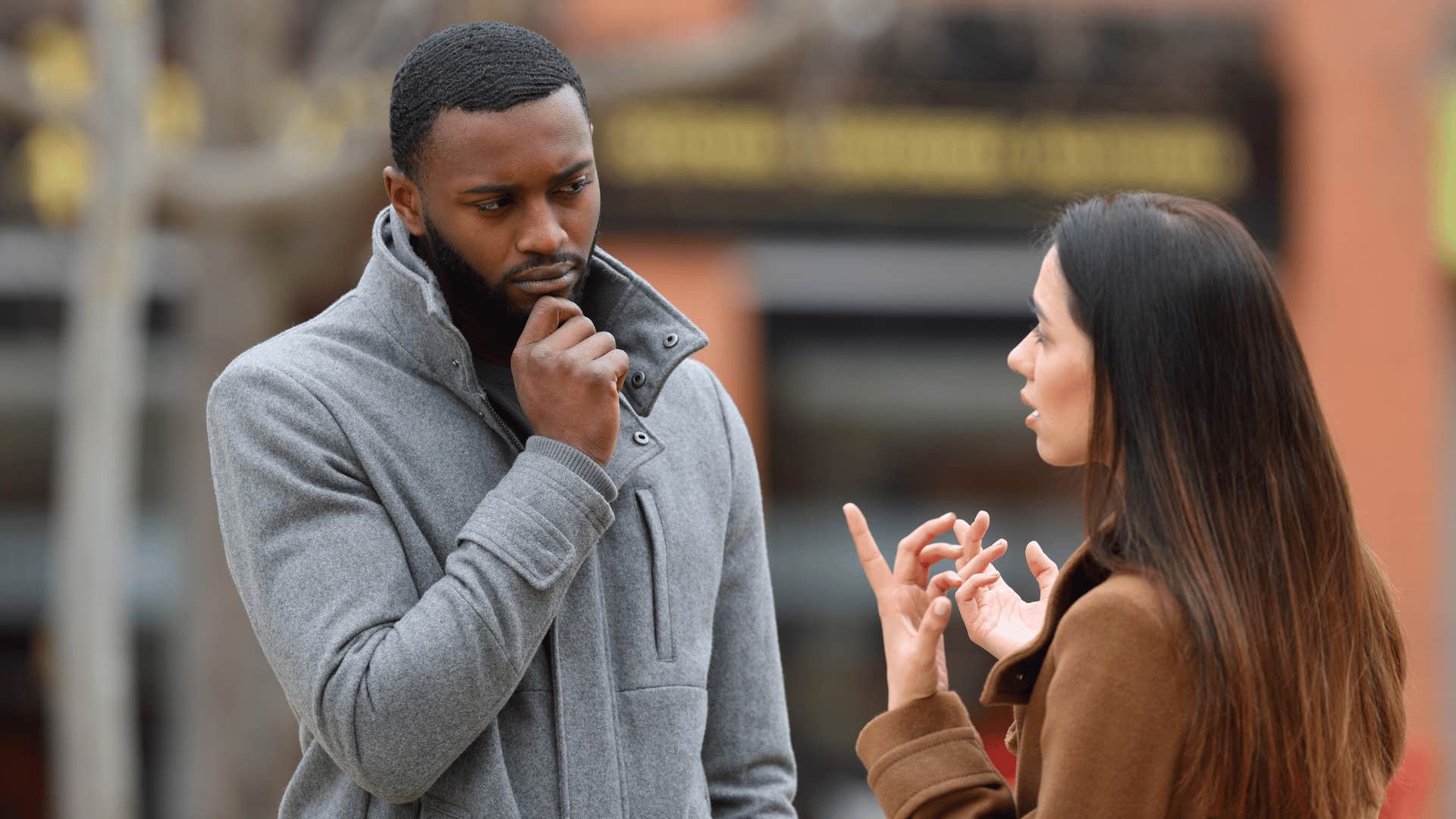 man thinking while listening to woman