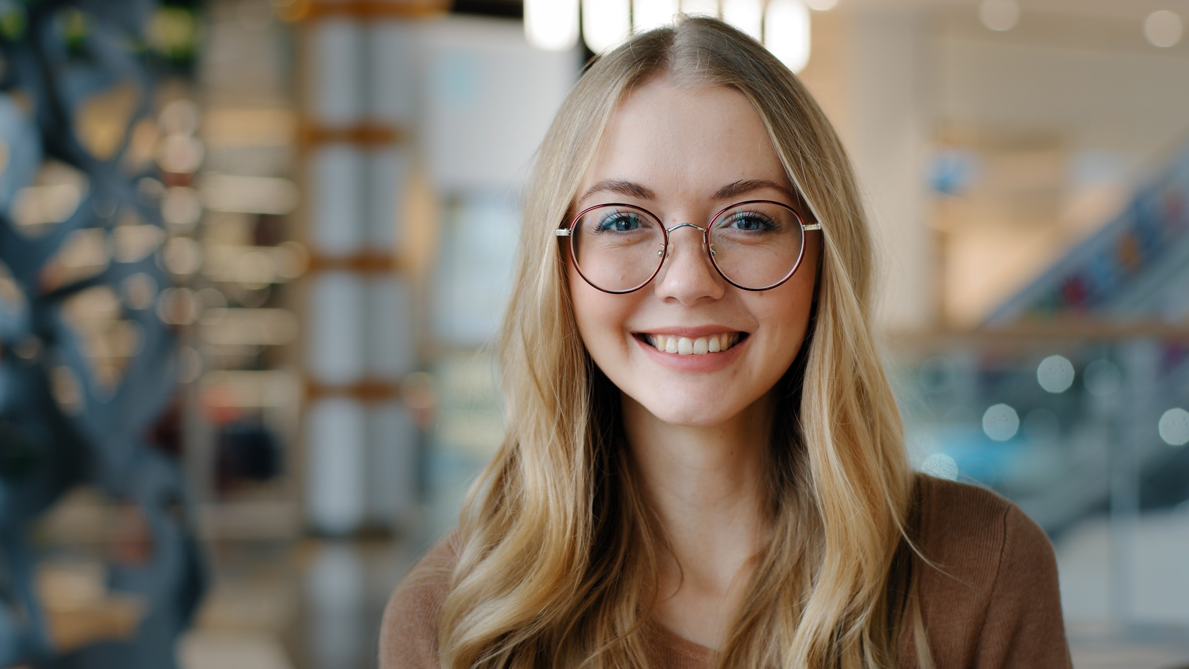 brilliant woman smiling wearing glasses