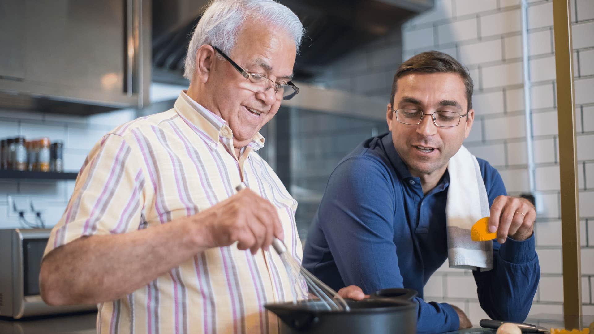 father and son making a meal together