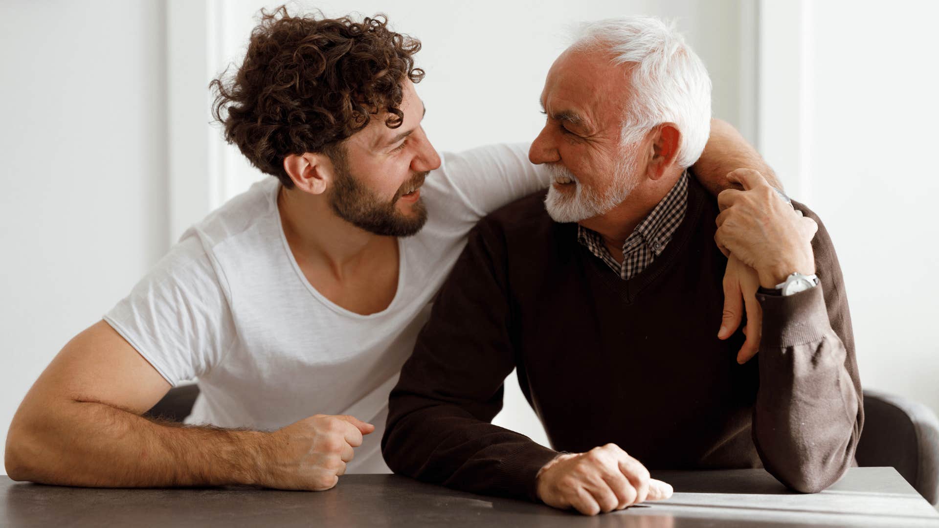 adult son and his father having a conversation