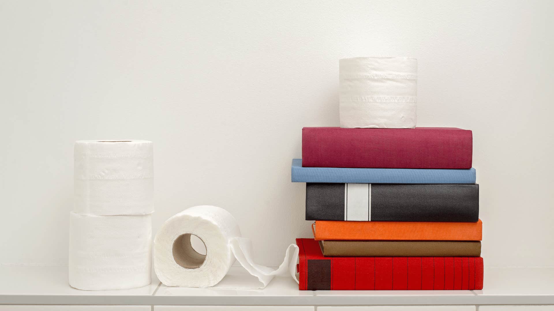 Neatly stacked towels and paper products in bathroom