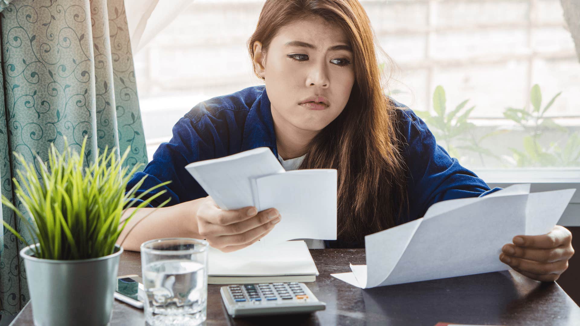 stressed woman trying to save money to pay debt