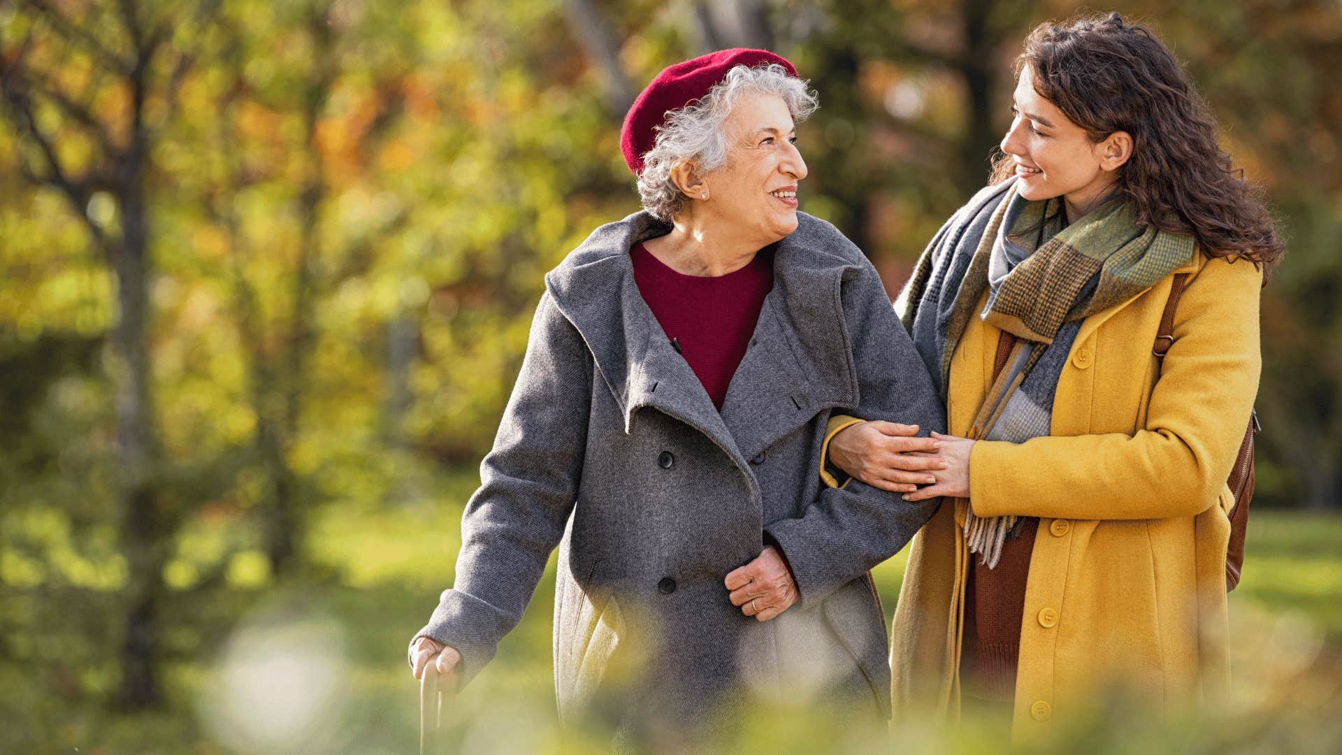 young compassionate woman helping older woman