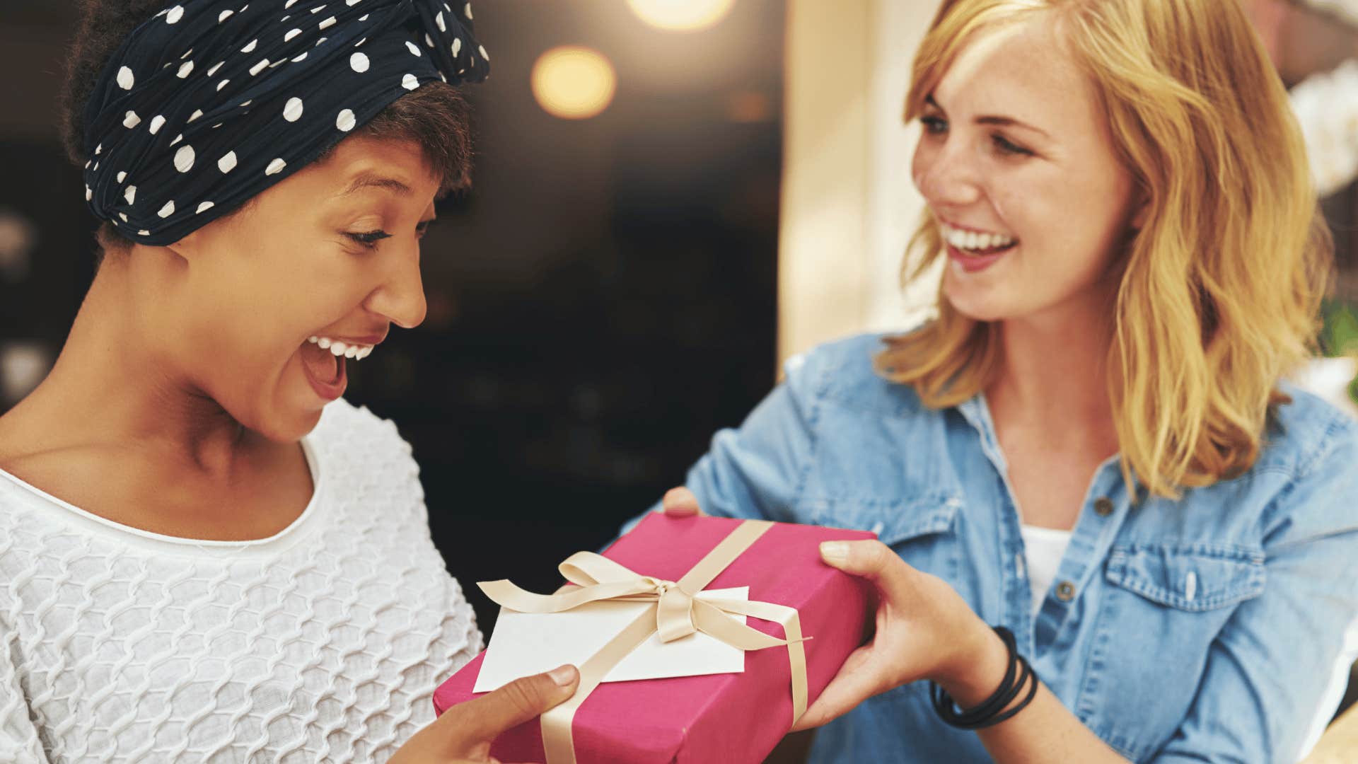 woman giving friend a gift