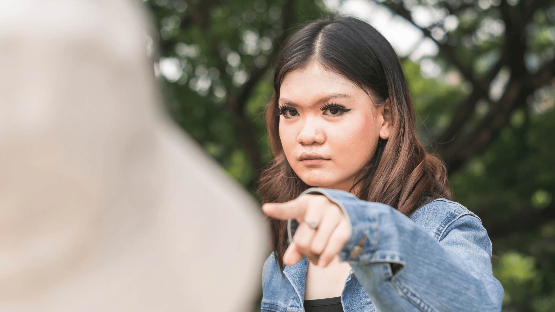 woman pointing finger to criticize someone