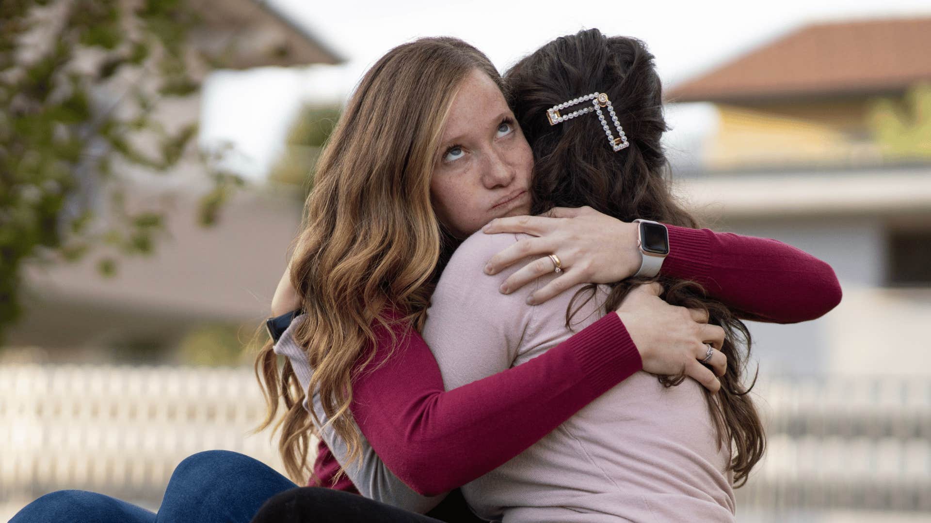 inauthentic woman being fake hugging friend