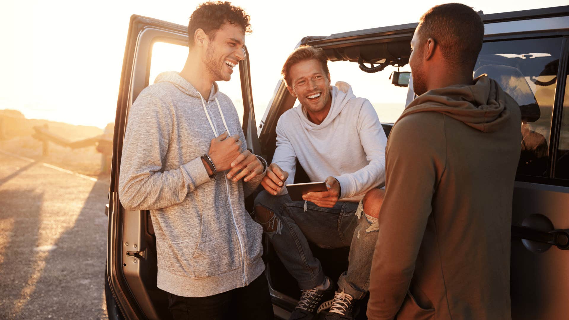 men hanging out outside car