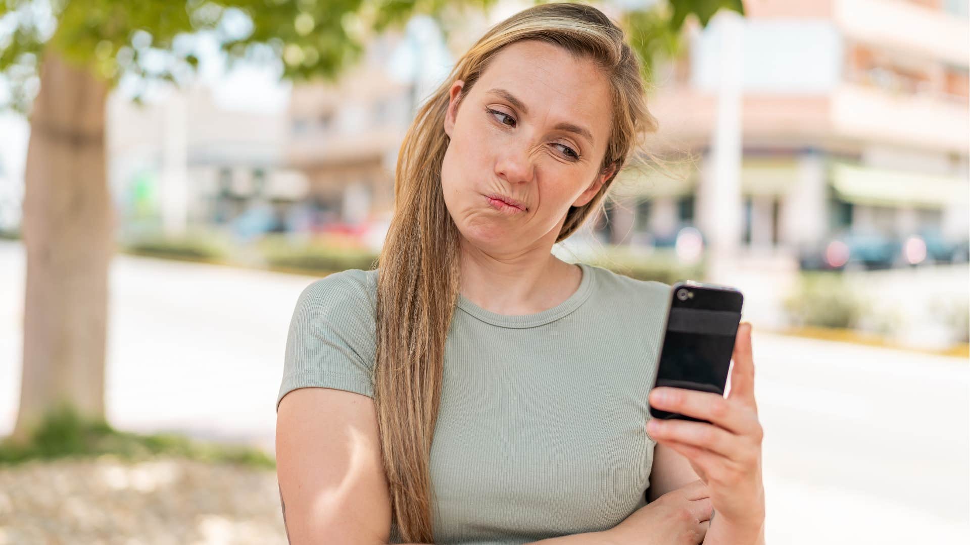 uncertain woman looking at her phone