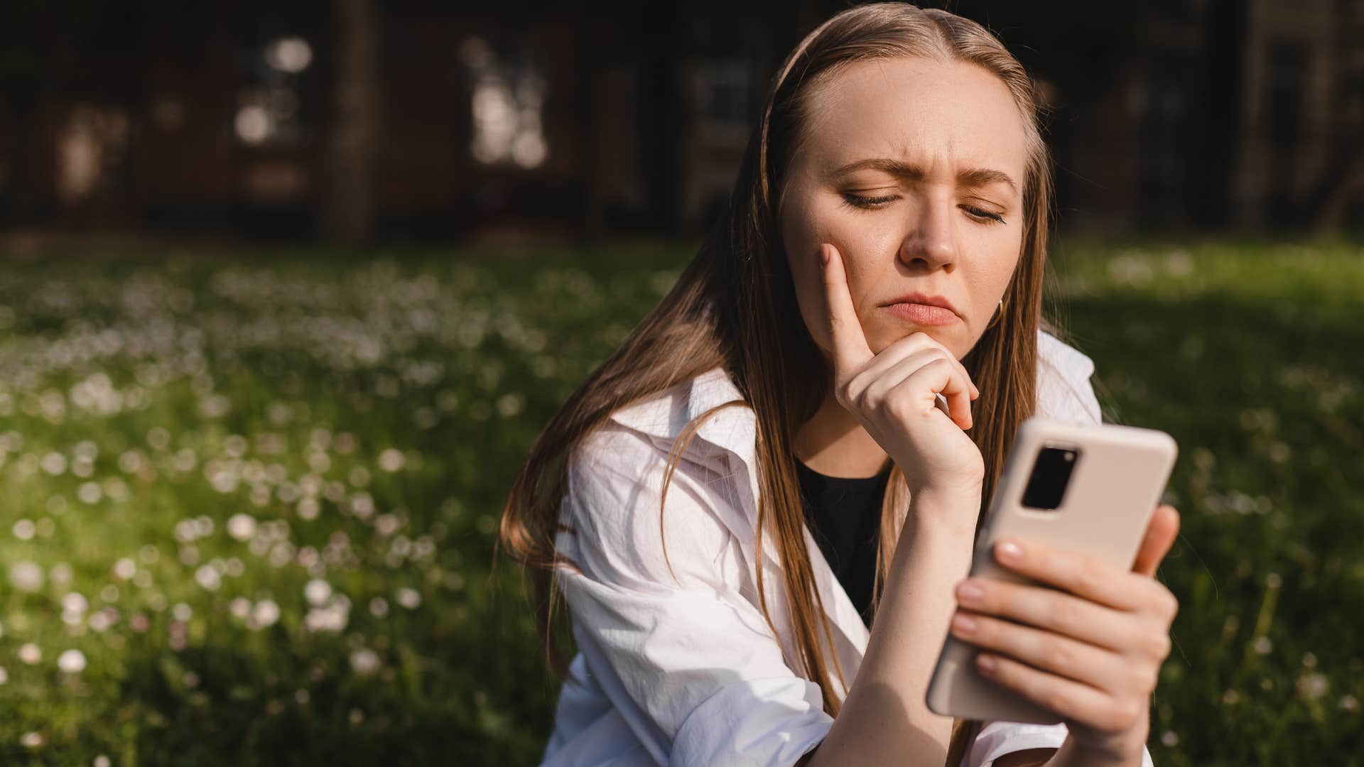 annoyed woman looking at her phone