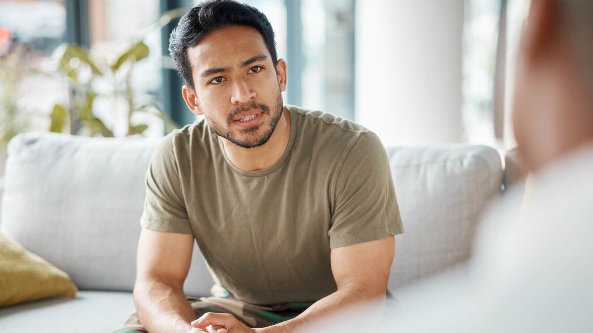 man talking to someone on the couch