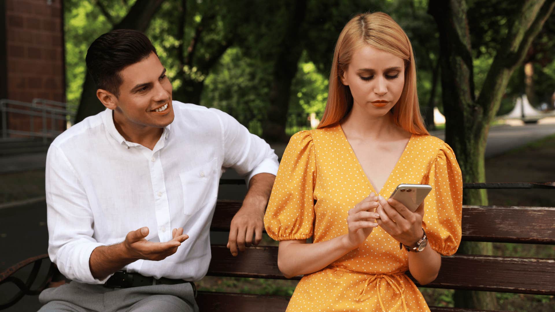 woman ignoring man trying to talk to her