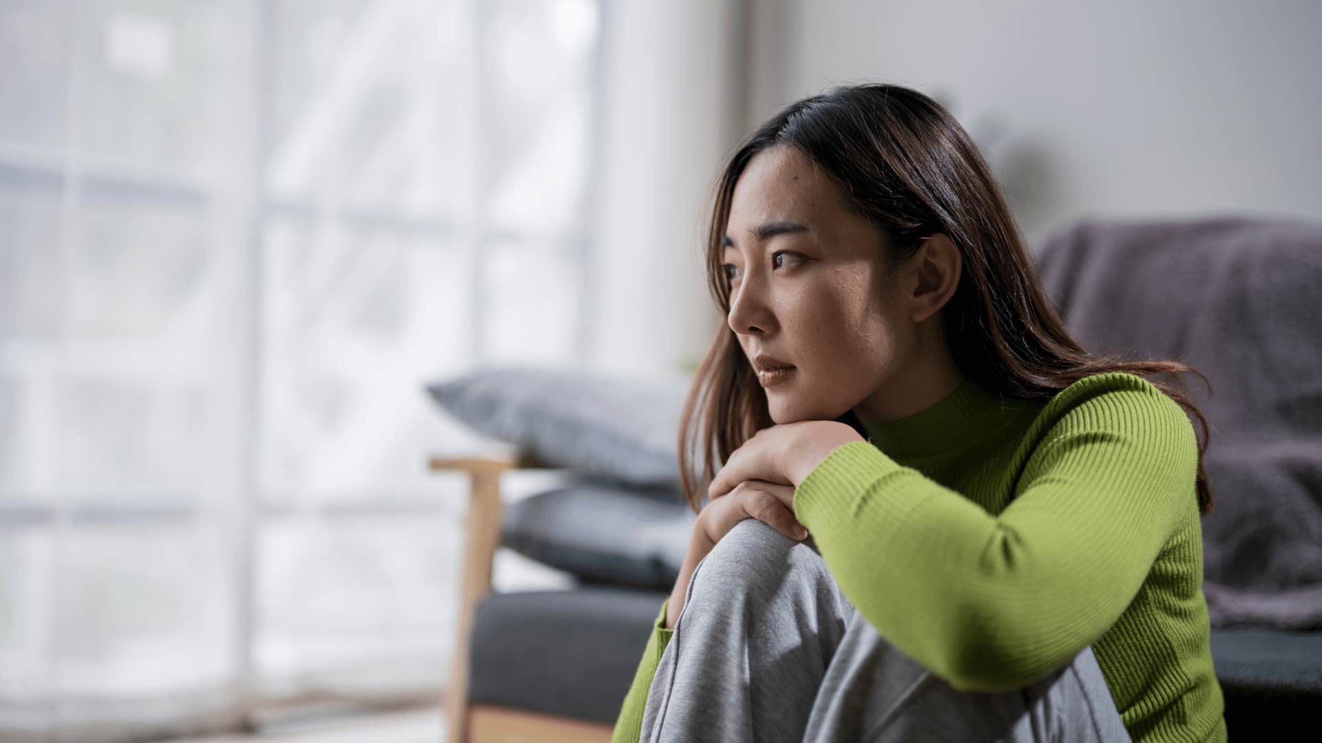 upset woman sitting on the floor