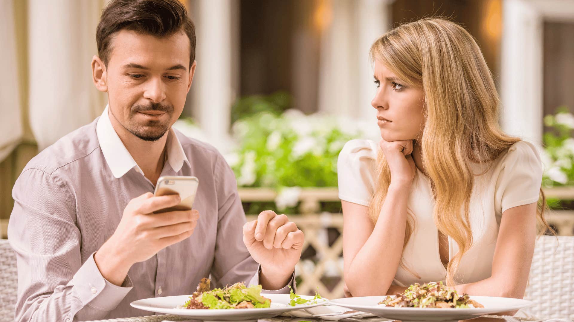 woman on date with man ignoring her