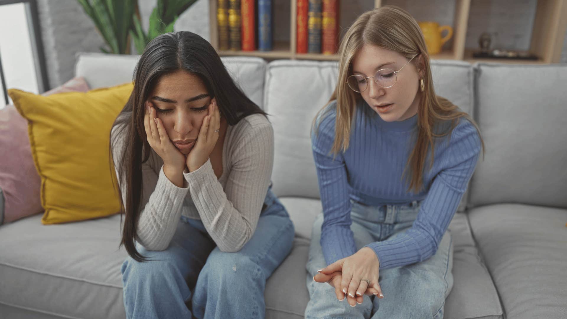 upset friends sitting on couch