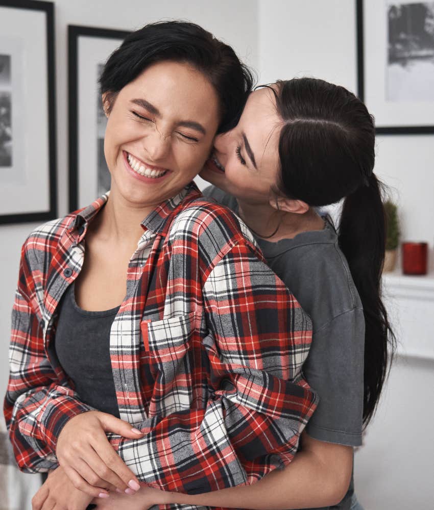 couple embracing in the living room knowing what makes best birthday gifts