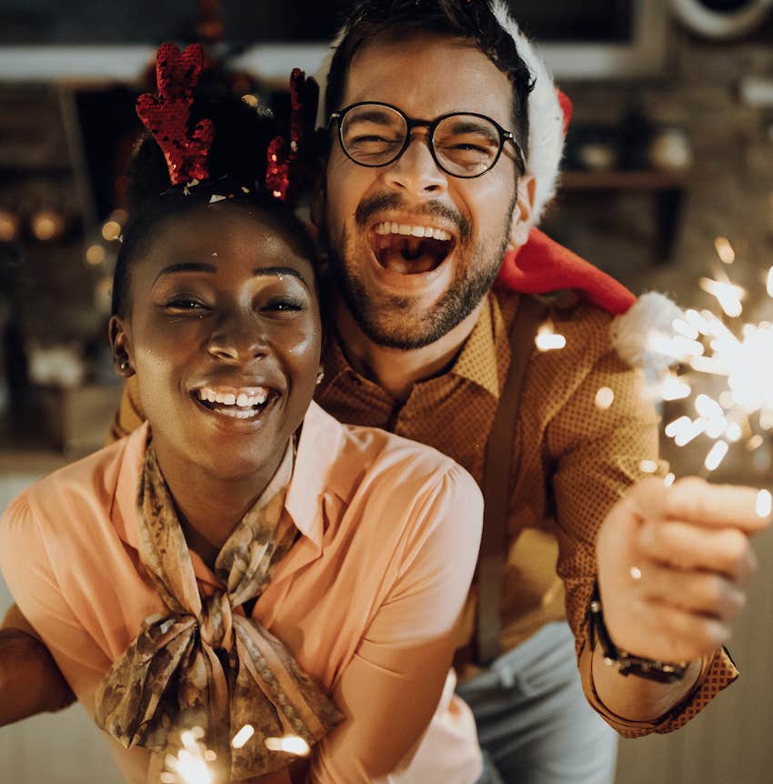 Excited couple celebrate with sparklers