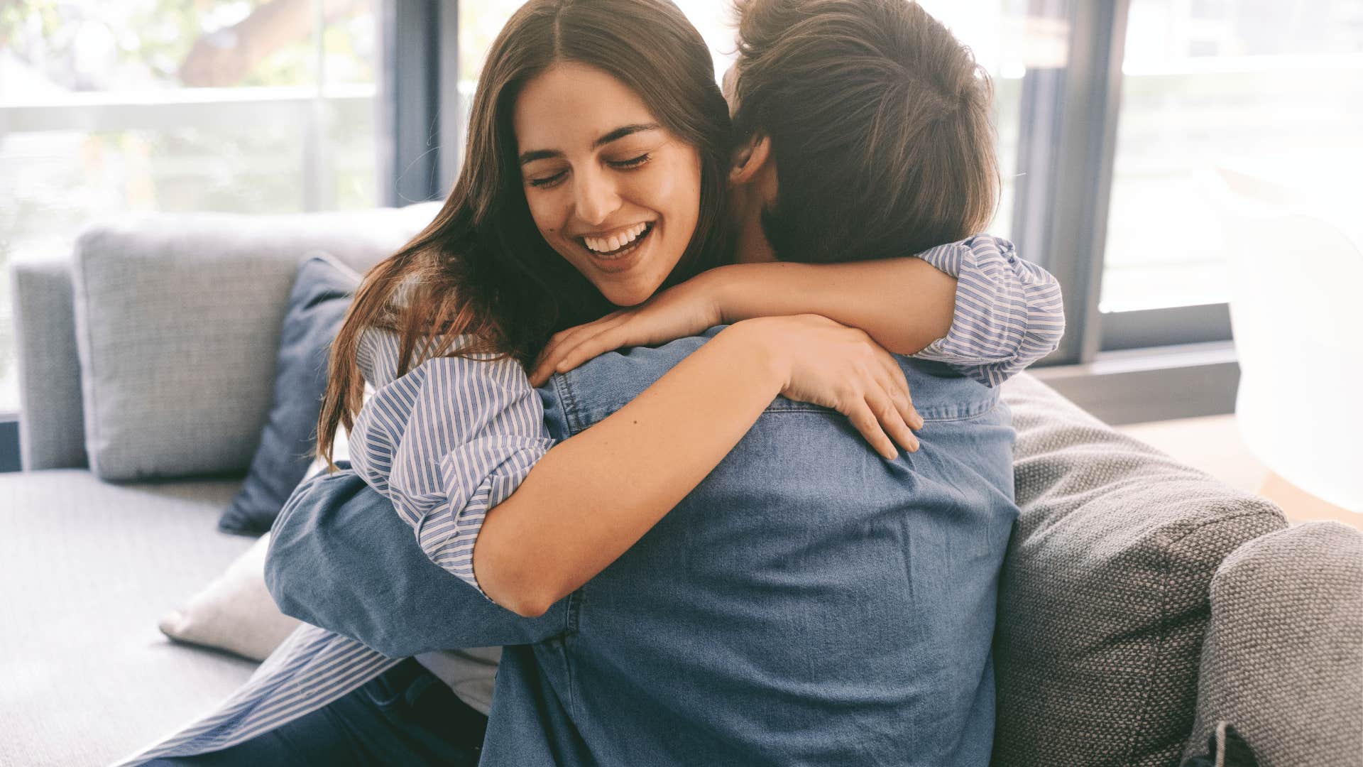 woman and man hugging on couch