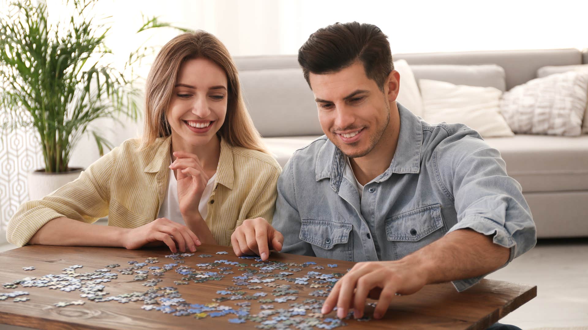 Gen Z couple doing boomer hobby jigsaw puzzle